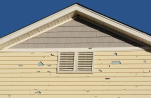 damaged pale yellow siding siding